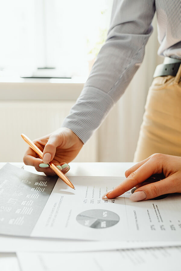 woman standing over financial chart